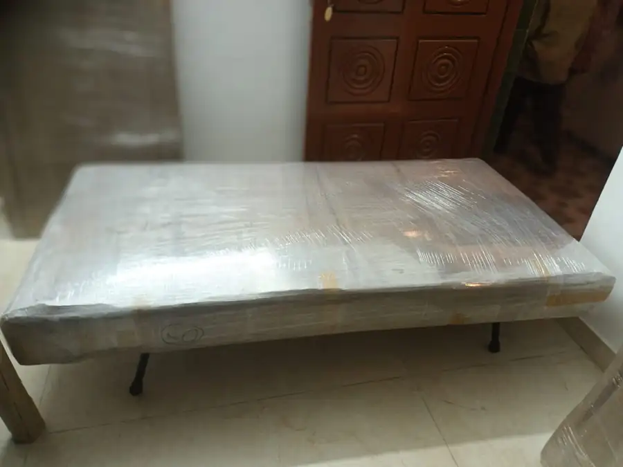 Cot and mattress wrapped before a household shift