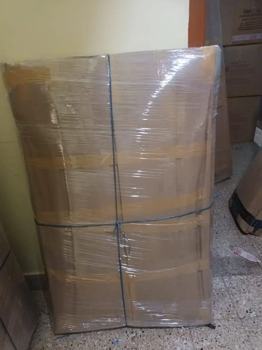 Wardrobe crated in corrugated board and roped for long-distance transport