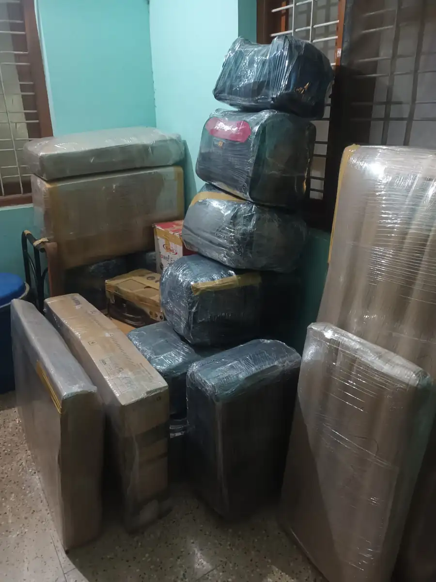 Packed luggage, mattresses and appliances staged for loading
